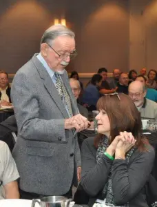 John L. McKnight engages with participants during his keynote address on Friday